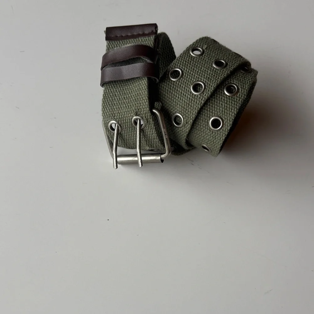 Olive Green Canvas Belt with brown accents. Silver tone hook loops.